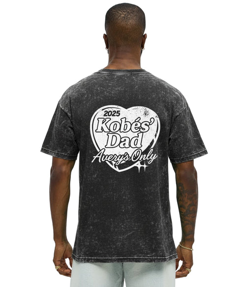 Man wearing a black t-shirt with text on the back against a white background