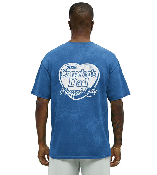 Man wearing a blue t-shirt with text on the back, standing against a white background